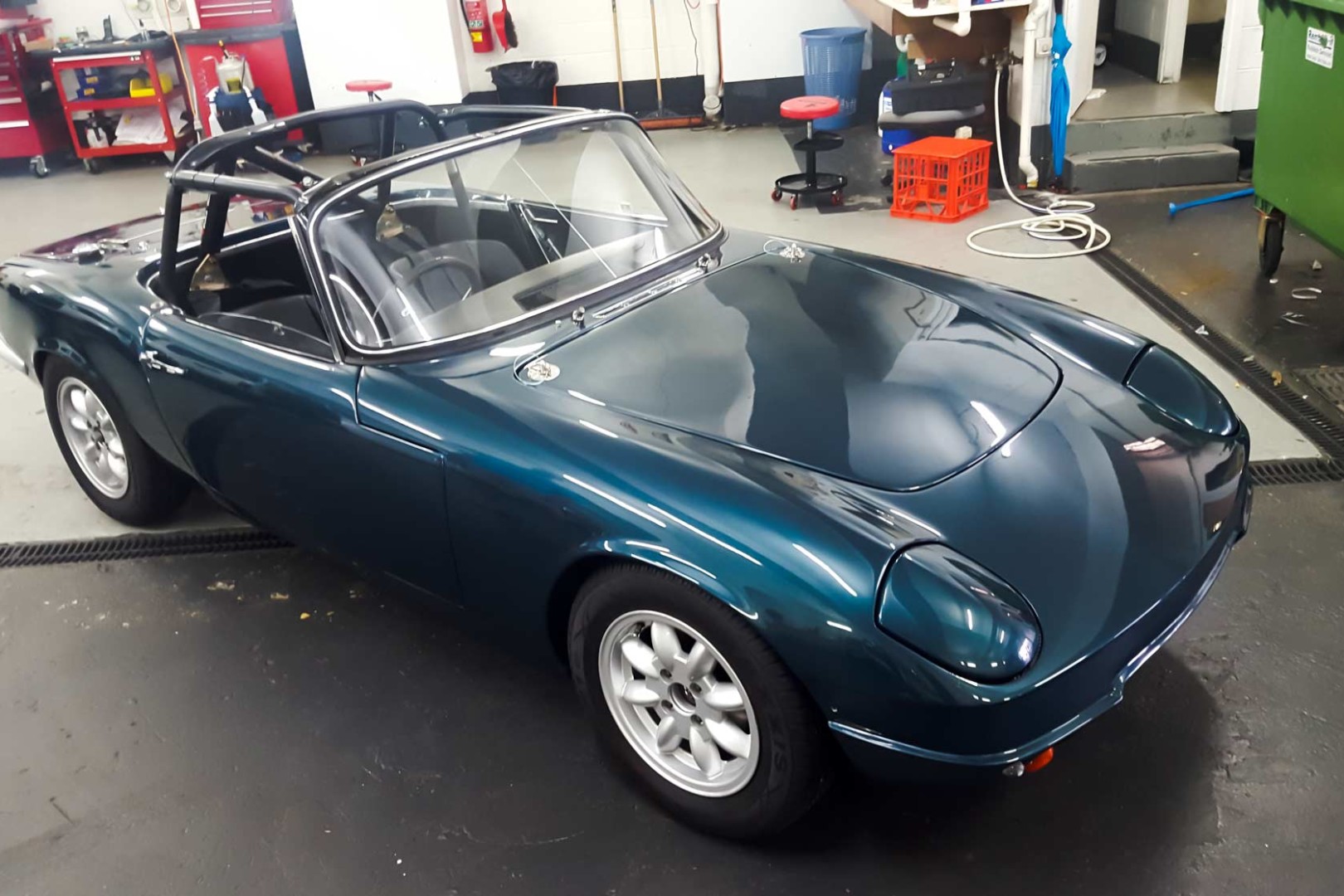 This 1964 Lotus Elan circuit racer has has the entire front end wrapped including headlights, lower fender, guards, and bonnet, to preserve its paint, and delicate fibreglass shell.